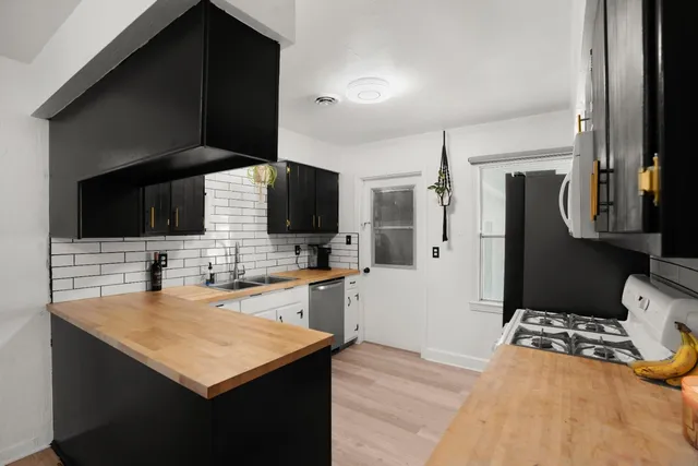 a kitchen with stainless steel appliances a sink stove and refrigerator