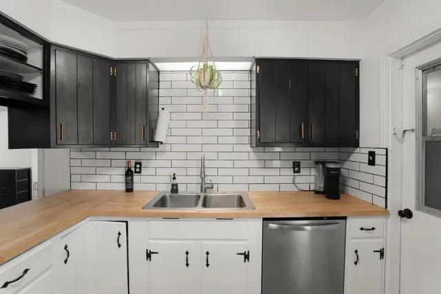 a kitchen with stainless steel appliances wooden cabinets and a sink