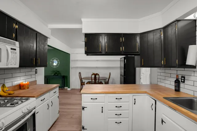 a kitchen with a sink stove and microwave