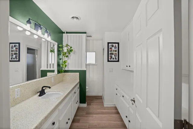 a bathroom with a tub a sink and mirror