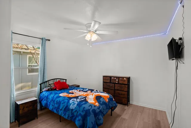 a bedroom with a bed and a chandelier