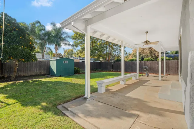 a view of a house with backyard and porch
