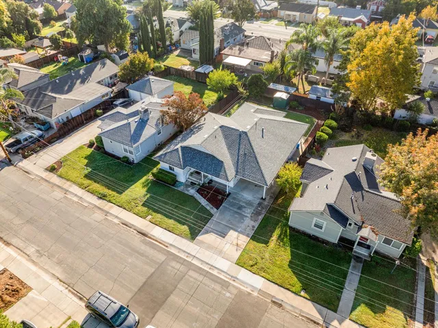 an aerial view of a house with garden space and street view