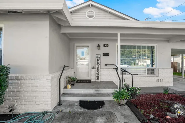 a front view of a house with outdoor seating