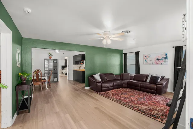 a living room with furniture and a wooden floor