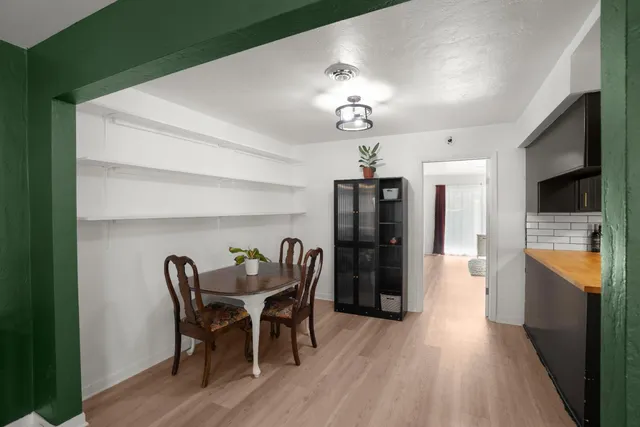 a view of a dining room with furniture and wooden floor