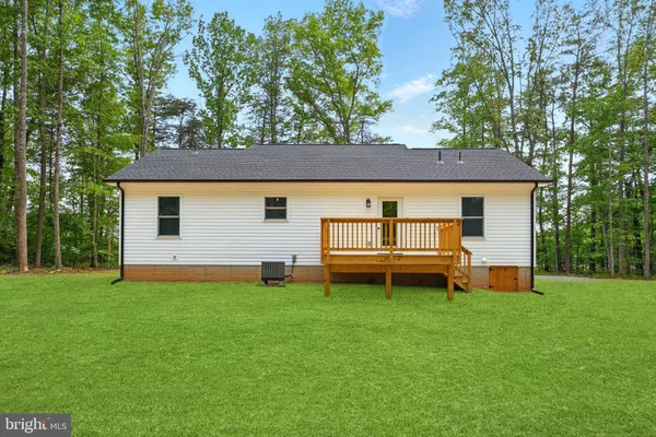 a view of a house with a yard and sitting area