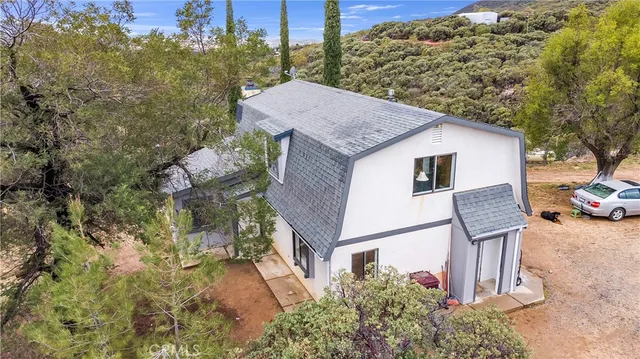 a view of a patio with table and chairs and wooden fence