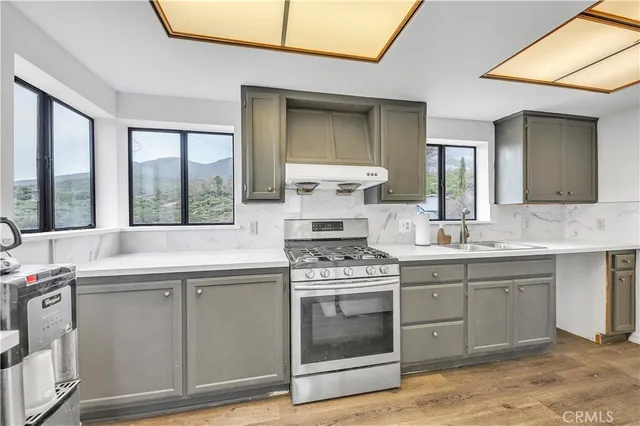 a kitchen with stainless steel appliances granite countertop a stove and cabinets