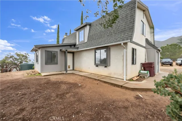 a view of a house with backyard and garage