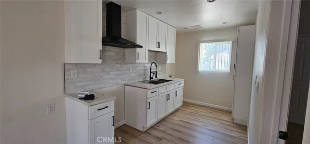 a kitchen with a sink stove and cabinets
