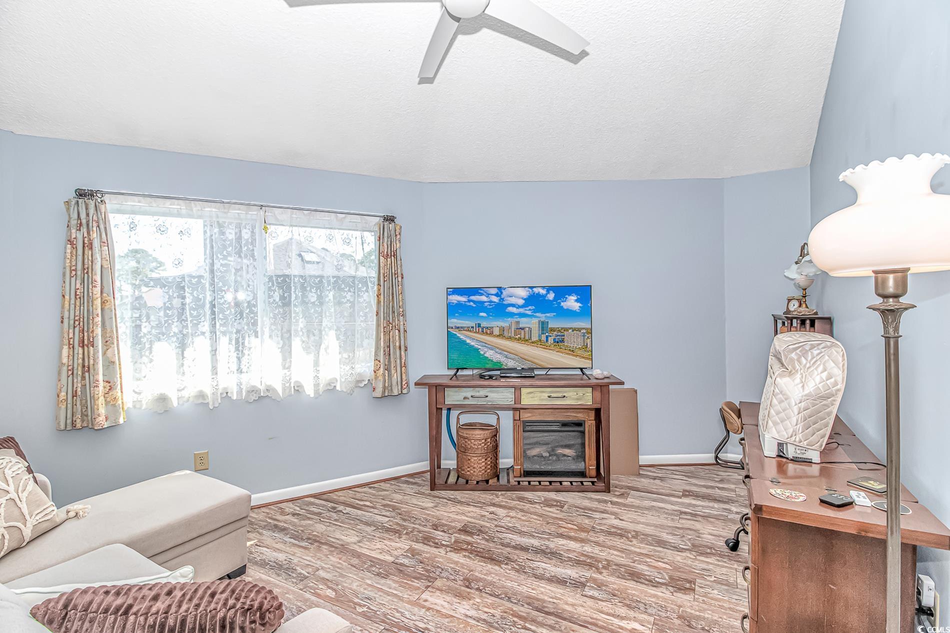 505 Tree Top Lane Myrtle Beach, SC 29588 - Photo 11 of 37 Living room featuring baseboards, a ceiling fan, w