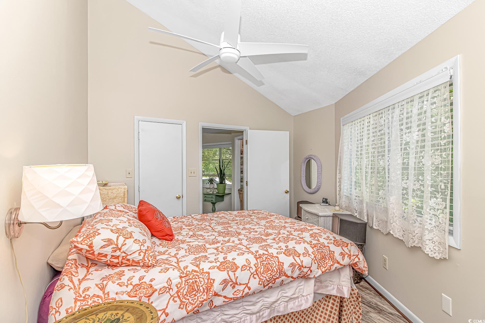 505 Tree Top Lane Myrtle Beach, SC 29588 - Photo 18 of 37 Bedroom with ceiling fan, a textured ceiling, vaul