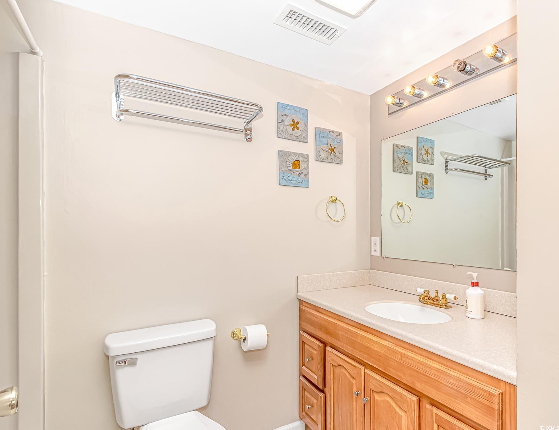 505 Tree Top Lane Myrtle Beach, SC 29588 - Photo 30 of 37 Bathroom featuring vanity, visible vents, and toil