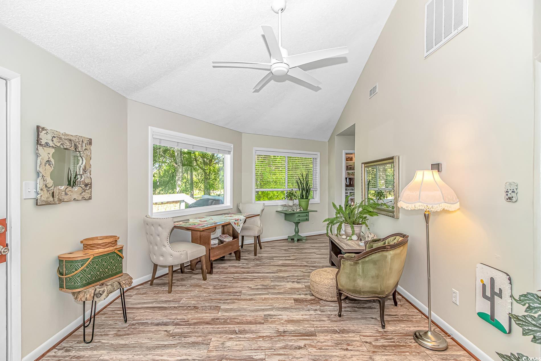 505 Tree Top Lane Myrtle Beach, SC 29588 - Photo 6 of 37 Living area with high vaulted ceiling, a ceiling f