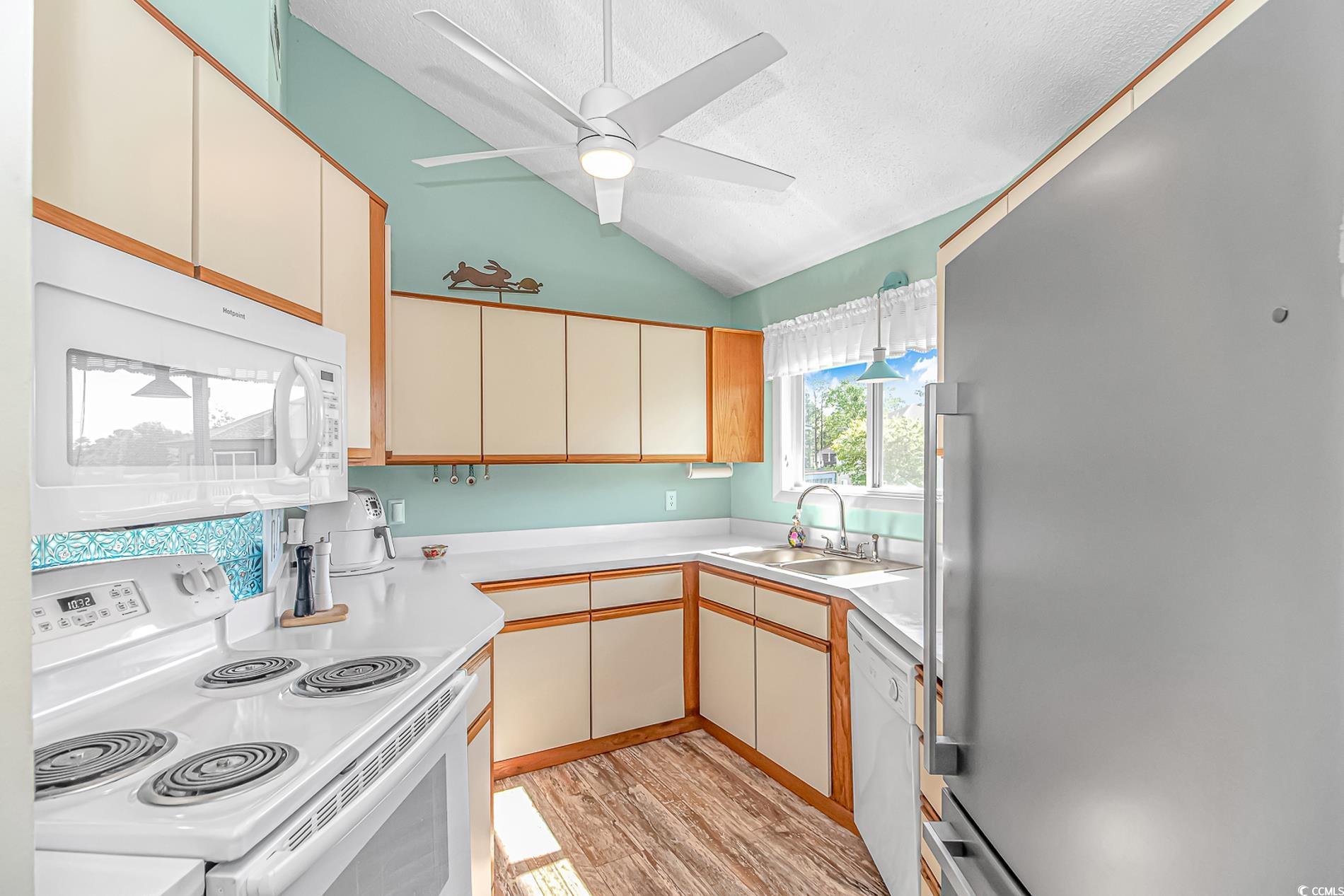 505 Tree Top Lane Myrtle Beach, SC 29588 - Photo 9 of 37 Kitchen featuring white appliances, a textured cei
