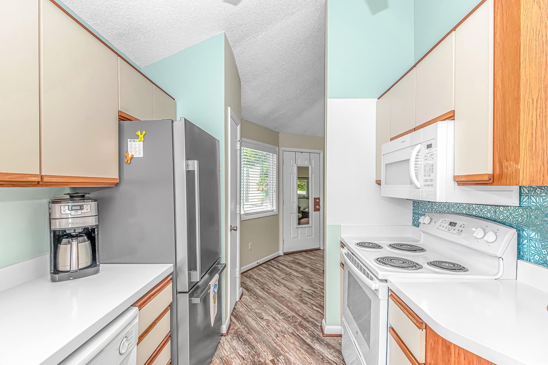505 Tree Top Lane Myrtle Beach, SC 29588 - Photo 10 of 37 Kitchen featuring baseboards, white appliances, li