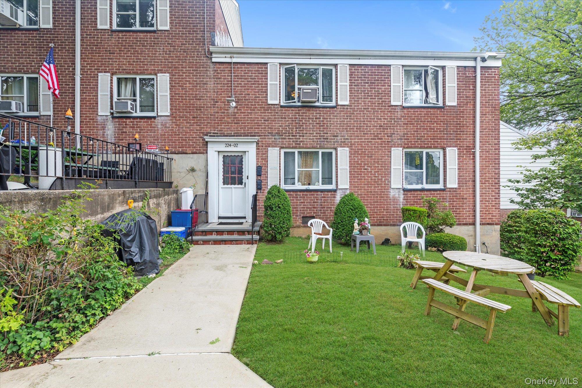 a front view of a house with a yard table and chairs