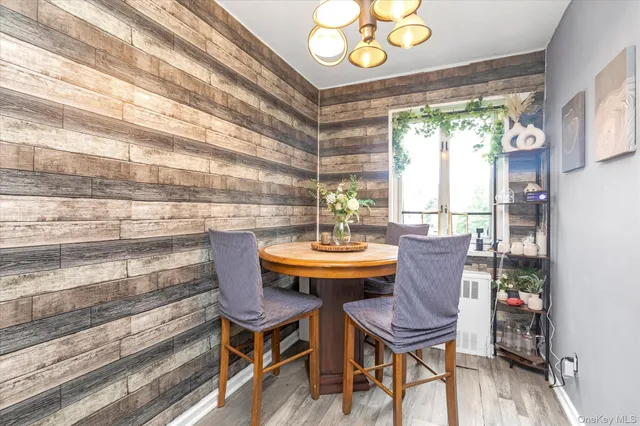 a view of a dining room with furniture a chandelier and wooden floor