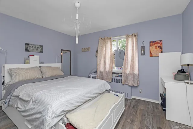 a spacious bedroom with a bed and a flat screen tv