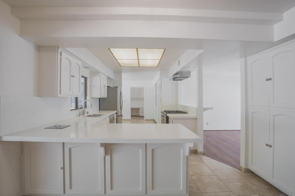 908 Vereda Del Ciervo Goleta, CA 93117 - Photo 13 of 35 a kitchen with stainless steel appliances a sink and a refrigerator