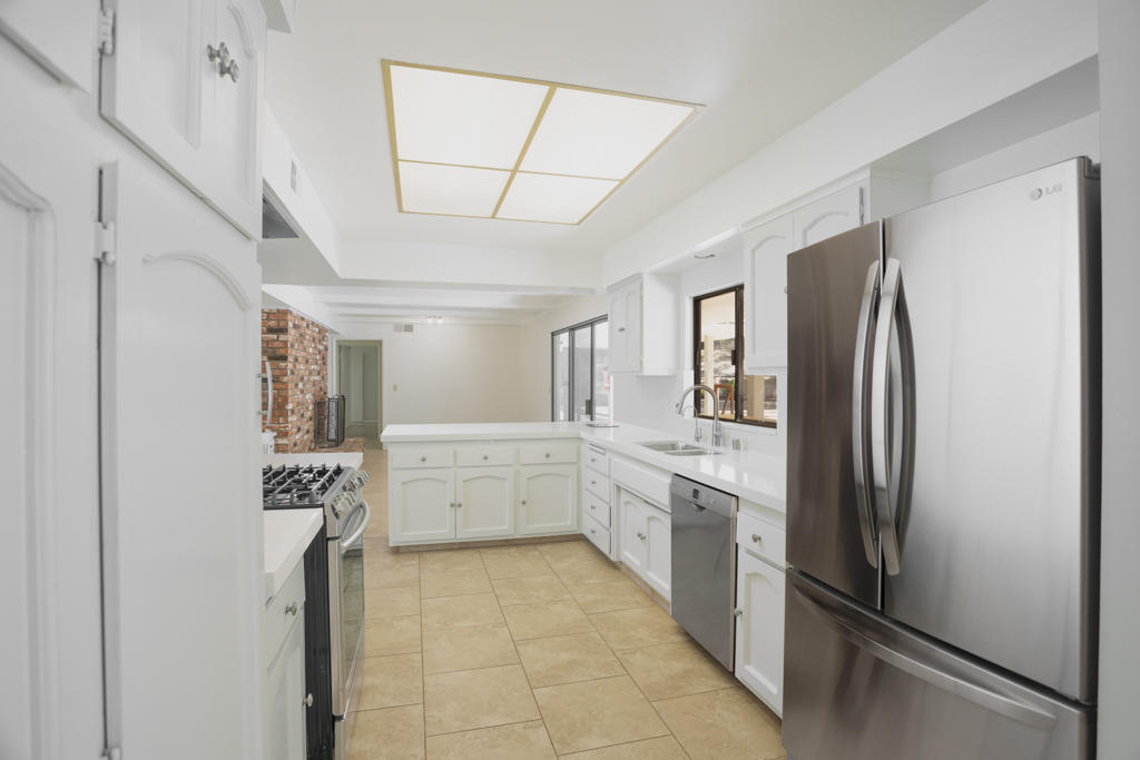 908 Vereda Del Ciervo Goleta, CA 93117 - Photo 14 of 35 a large white kitchen with cabinets and stainless steel appliances