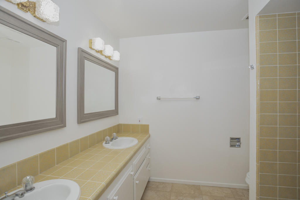 908 Vereda Del Ciervo Goleta, CA 93117 - Photo 28 of 35 a bathroom with a granite countertop sink and a mirror