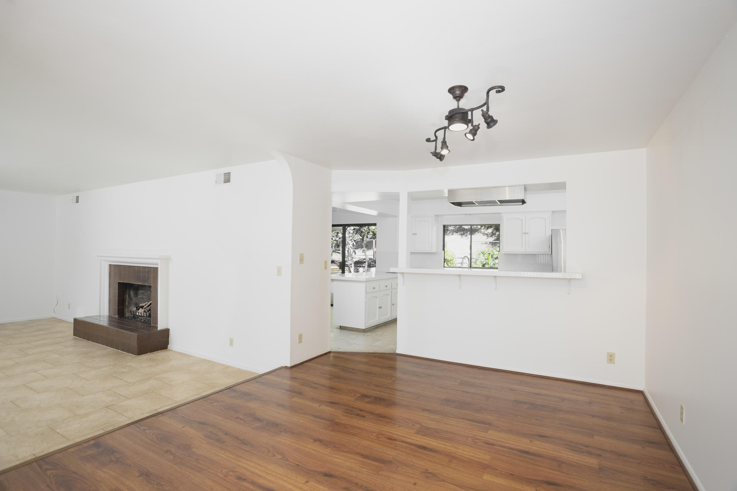 908 Vereda Del Ciervo Goleta, CA 93117 - Photo 7 of 35 a view of a kitchen with wooden cabinet and a fireplace