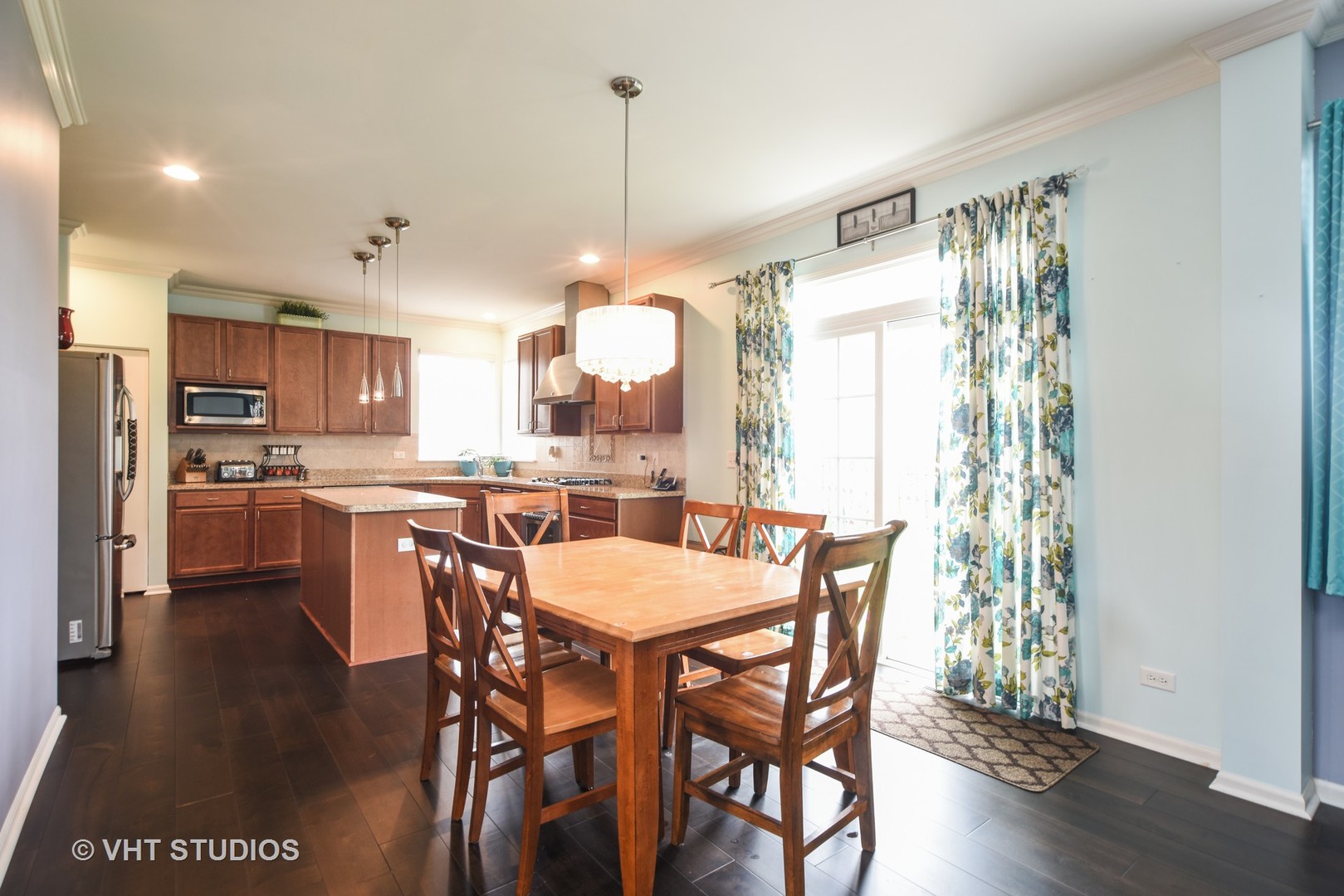 1439 Viola Lane Volo, IL 60073 - Photo 5 of 10 a view of a dining room and livingroom with furniture wooden floor a chandelier