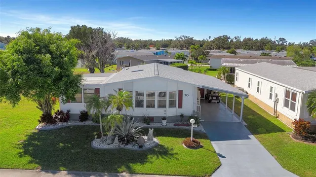 a aerial view of a house with swimming pool and a yard