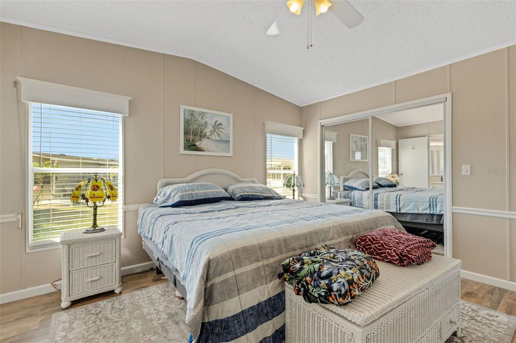 70 Mockingbird Lane Ellenton, FL 34222 - Photo 11 of 67 a bedroom with a bed and a chandelier