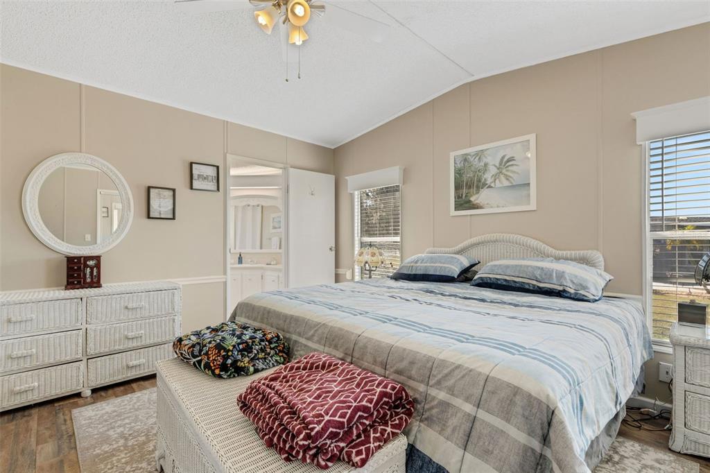 70 Mockingbird Lane Ellenton, FL 34222 - Photo 12 of 67 a bedroom with a bed a mirror on dresser and a window