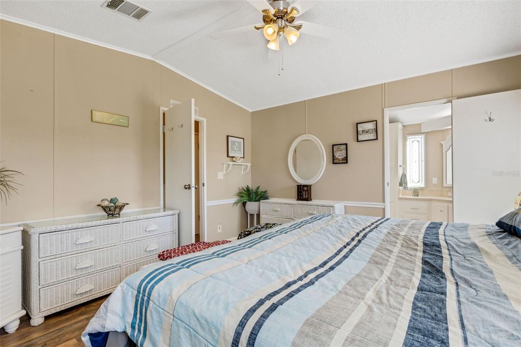 70 Mockingbird Lane Ellenton, FL 34222 - Photo 13 of 67 a bedroom with a bed and a chandelier