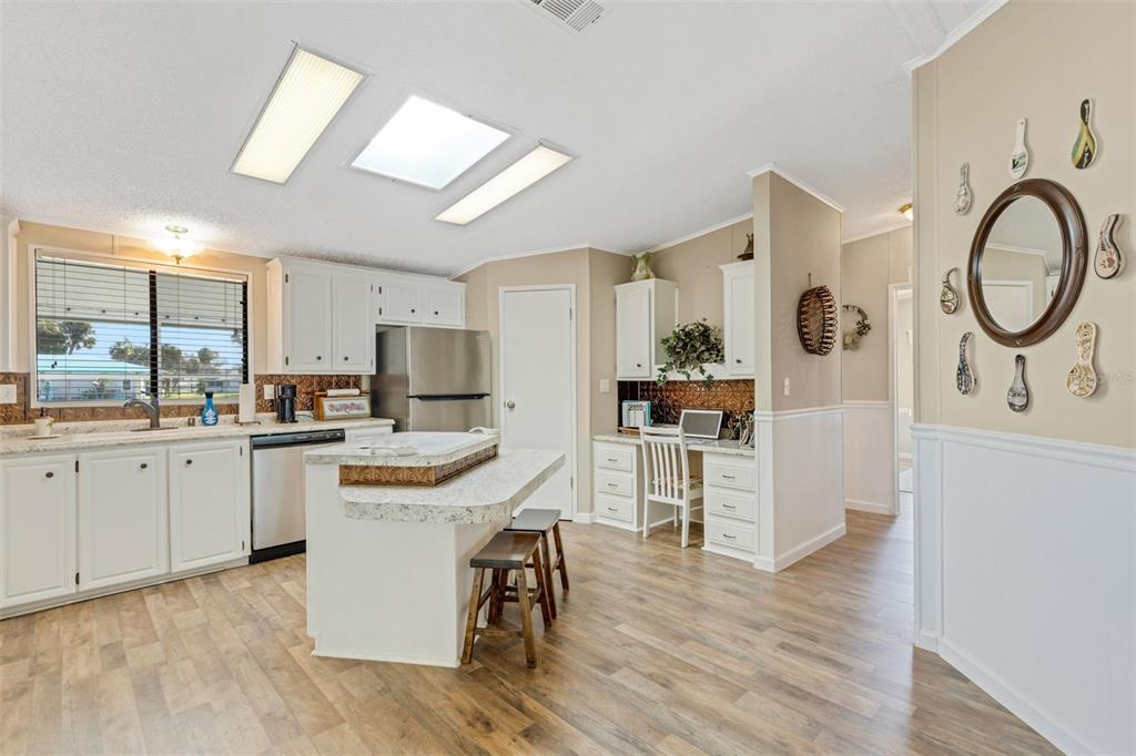 70 Mockingbird Lane Ellenton, FL 34222 - Photo 15 of 67 a kitchen with white cabinets and stainless steel appliances