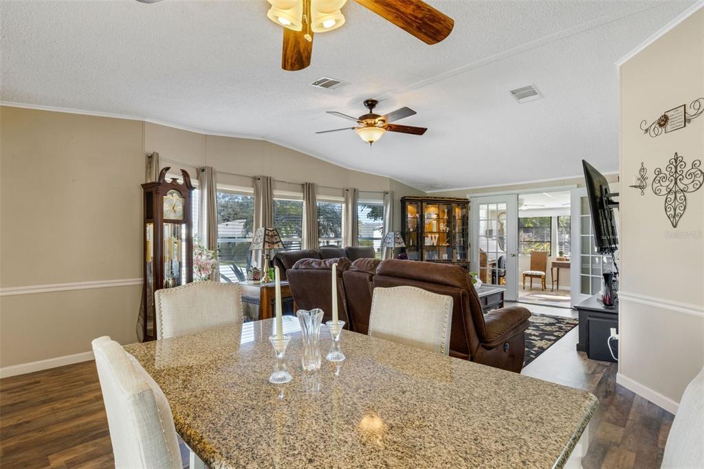 70 Mockingbird Lane Ellenton, FL 34222 - Photo 27 of 67 a view of a dining room with furniture a chandelier and wooden floor