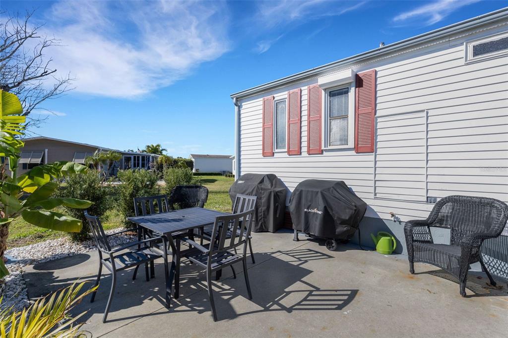 70 Mockingbird Lane Ellenton, FL 34222 - Photo 38 of 67 a view of a patio with table and chairs and potted plants