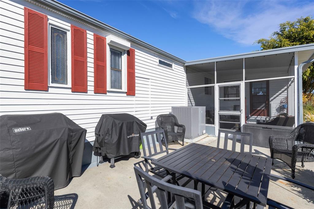 70 Mockingbird Lane Ellenton, FL 34222 - Photo 39 of 67 a view of a patio with table and chairs with wooden floor and plants