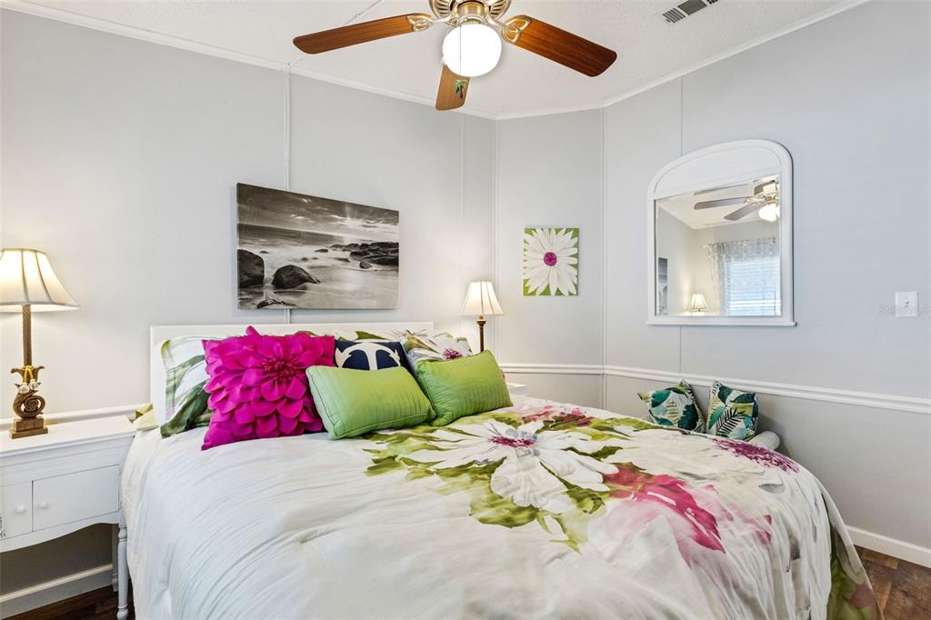 70 Mockingbird Lane Ellenton, FL 34222 - Photo 4 of 67 a bedroom with a bed and a chandelier