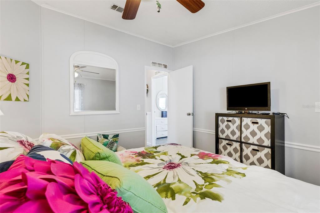 70 Mockingbird Lane Ellenton, FL 34222 - Photo 5 of 67 a bedroom with a bed and a flat screen tv