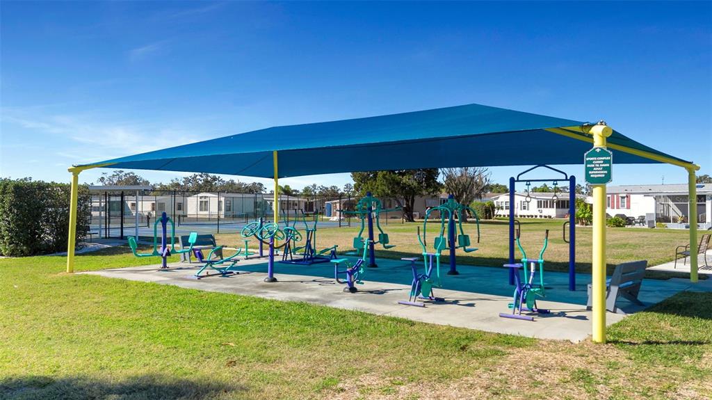 70 Mockingbird Lane Ellenton, FL 34222 - Photo 63 of 67 a view of a patio with a table and chairs under an umbrella