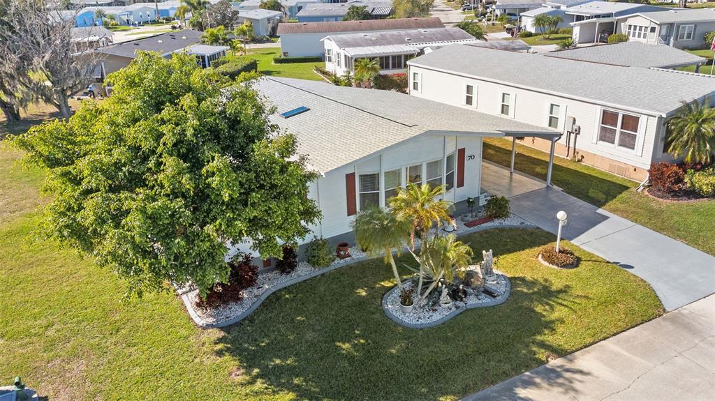 70 Mockingbird Lane Ellenton, FL 34222 - Photo 65 of 67 a view of an house with swimming pool lawn chairs and a yard