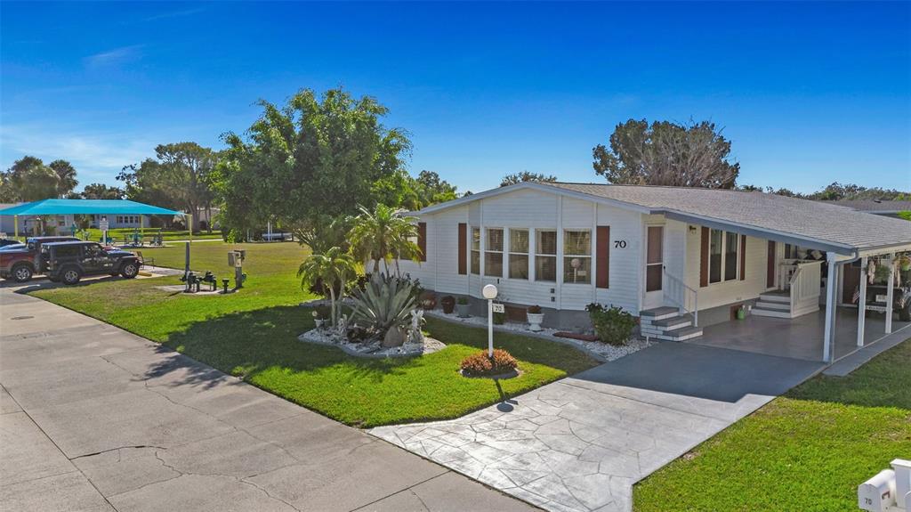 70 Mockingbird Lane Ellenton, FL 34222 - Photo 66 of 67 a front view of a house with a garden and sitting area