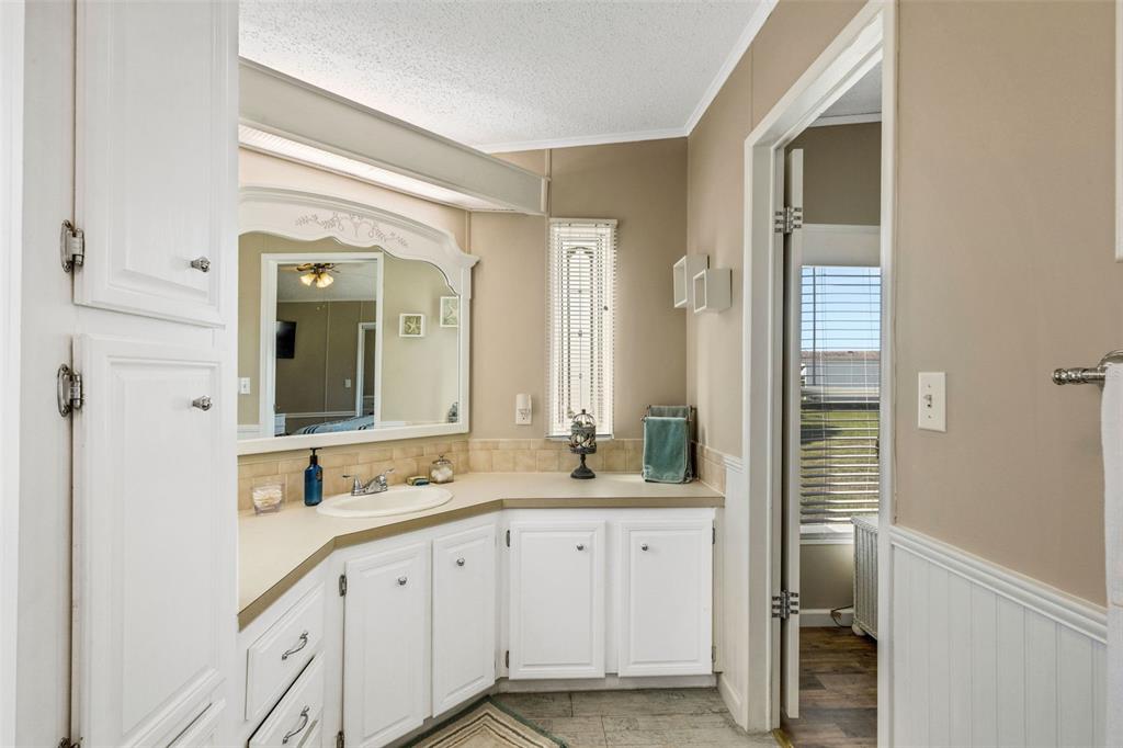 70 Mockingbird Lane Ellenton, FL 34222 - Photo 9 of 67 a bathroom with a double vanity sink and a mirror