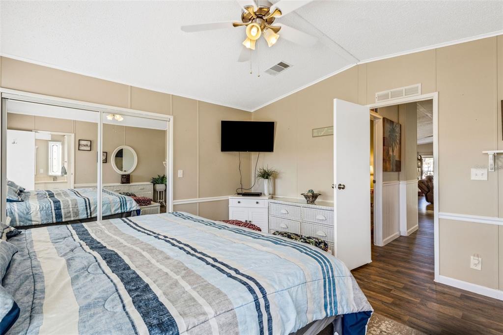 70 Mockingbird Lane Ellenton, FL 34222 - Photo 10 of 67 a bedroom with a bed and wooden floor