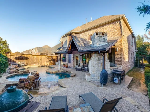 a view of a house with backyard porch and sitting area