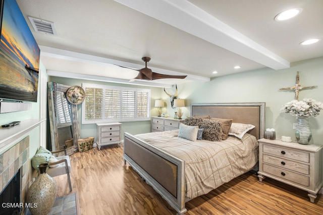 a bedroom with a large bed and a window