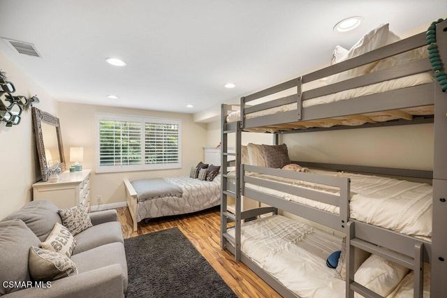 a bedroom with furniture and a window