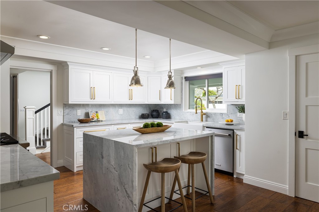 1609 Ruth Lane Newport Beach, CA 92660 - Photo 13 of 39 a kitchen with a stove a sink a window and stainless steel appliances