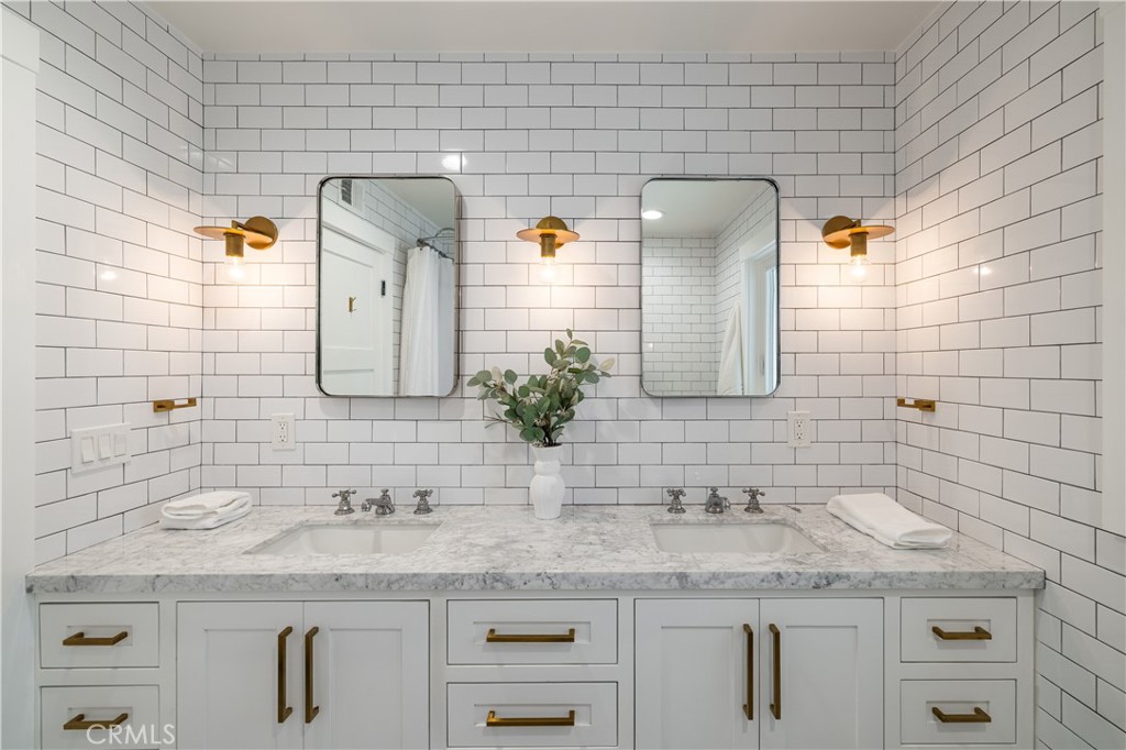 1609 Ruth Lane Newport Beach, CA 92660 - Photo 21 of 39 a bathroom with a granite countertop sink and a mirror