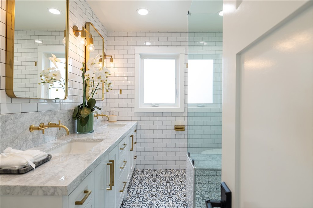 1609 Ruth Lane Newport Beach, CA 92660 - Photo 25 of 39 a bathroom with a granite countertop sink a large mirror and a shower